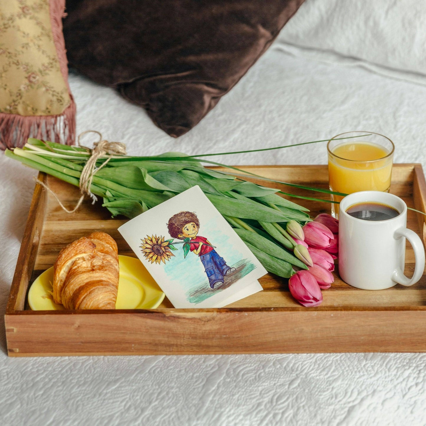 Sunflower Boy Greeting Card - Hand Painted | Watercolor Print displayed on a wooden tray with tulips, croissant, and coffee. Ideal for gifting.