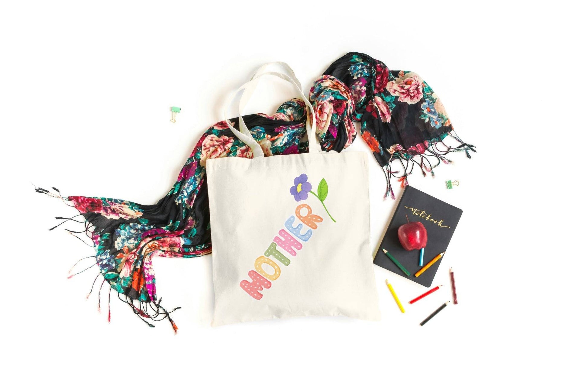 Colorful Mother Tote Bag with flower design, styled with floral scarf, notebook, and crayons. Celebrate Mom in style with this cheerful gift bag.