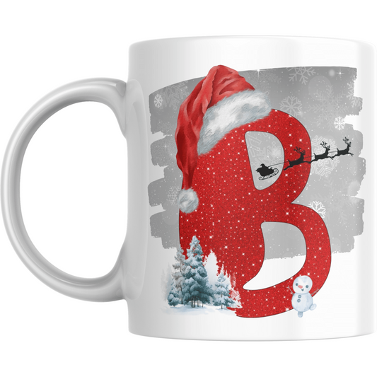 Christmas Mug with Letter B & Santa Print featuring red glitter-style B, Santa sleigh silhouette, snowman, and snowy trees on white ceramic.