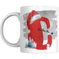 Christmas Mug with Letter C & Santa Print featuring red glitter-style C, Santa sleigh silhouette, snowman, and winter trees on white ceramic.