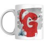 Christmas Mug with Letter G & Santa Print featuring red glitter letter, Santa hat, sleigh silhouette, snowman, and snowy trees on white ceramic.