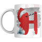 Christmas mug with red letter H wearing Santa hat, snowflakes, snowman, and pine trees. Holiday mug perfect for festive gifts and hot drinks.