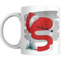 Christmas mug with red letter S wearing Santa hat, sleigh silhouette, snowman, and snowy trees. Festive ceramic drinkware for holiday gifting.
